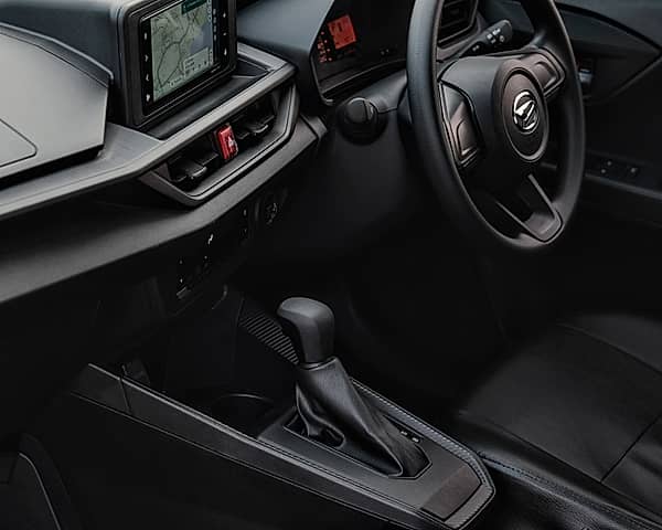 Interior view - car's dashboard with a touchscreen infotainment system and a steering wheel.