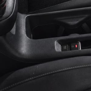 Close-up of a car's black interior, highlighting the center console.