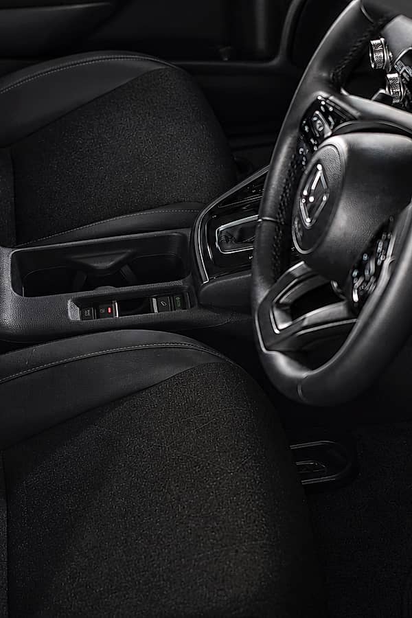 Close-up of a car's black interior, highlighting the center console.
