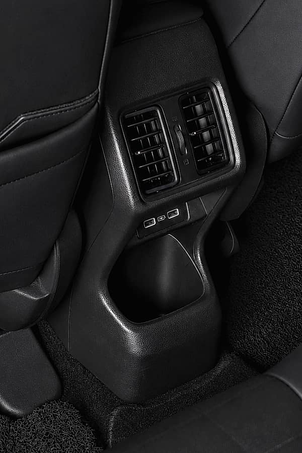 Interior shot of the back seat of a car, featuring air vents and USB ports for passengers.