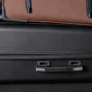 View from the rear of a beige Honda HRV with its trunk open, revealing luggage packed for a trip.
