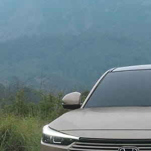 Front view of a tan Honda HR-V SUV positioned on a natural landscape with a vast mountain vista.
