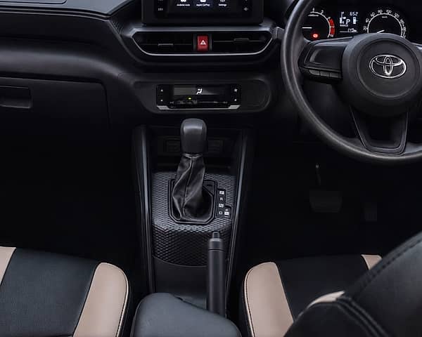 Interior view of a dashboard with a touchscreen infotainment system and steering wheel.
