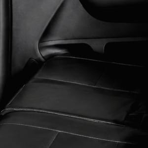 Interior view of Mitsubishi Xpander backseat with black seats and visible seatbelts.