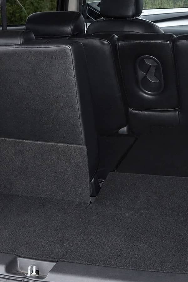 Black car's spacious and clean trunk with folded-down rear seats for maximum cargo capacity.